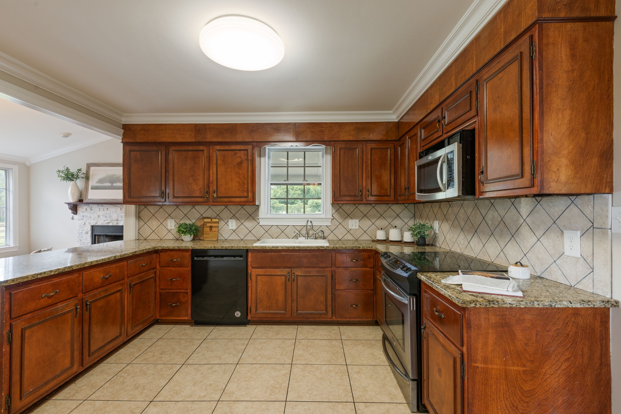 1586 Coleman Road Franklin, TN 37064 - Photo 12 of 73 a kitchen with a sink a stove top oven and cabinets