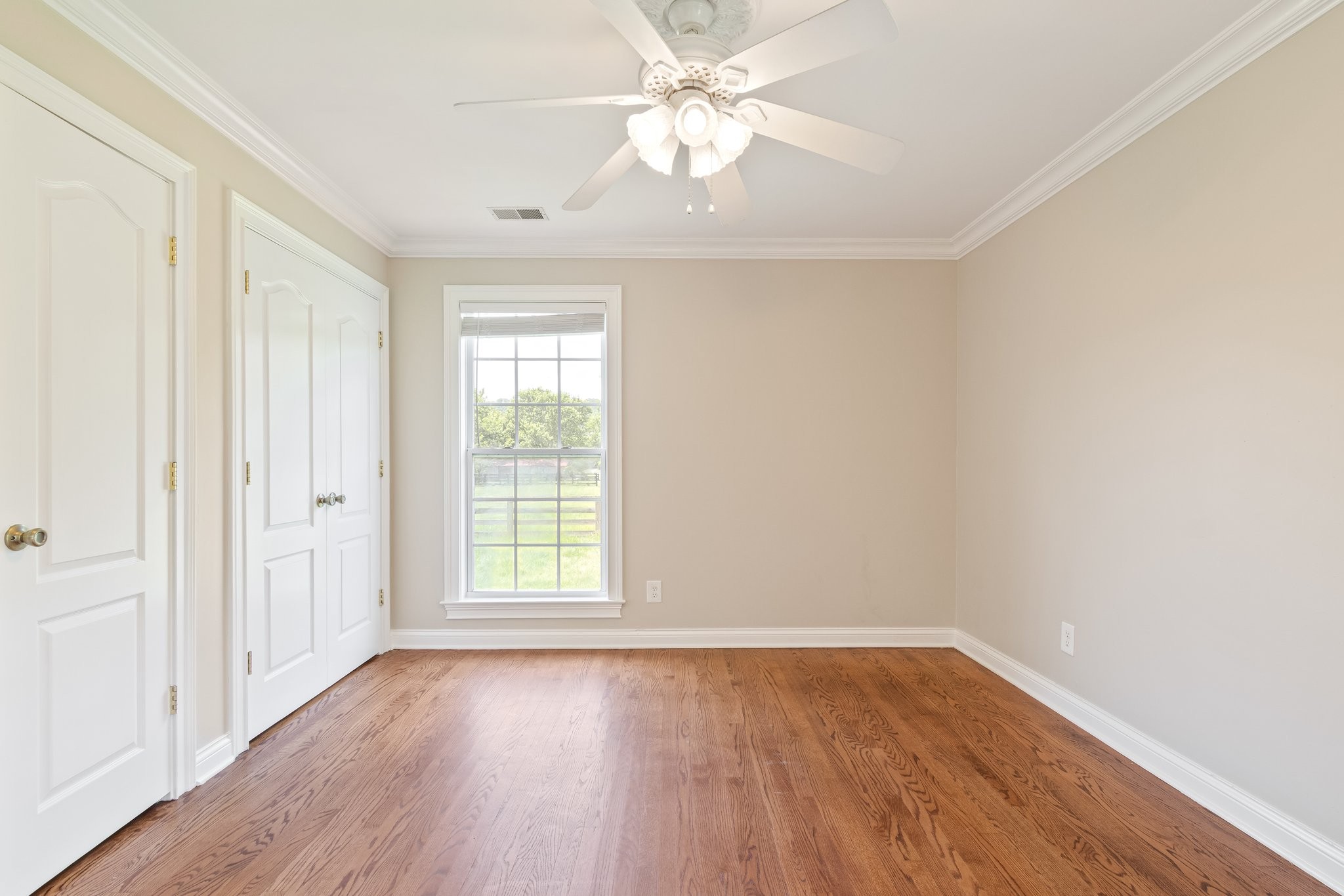1586 Coleman Road Franklin, TN 37064 - Photo 26 of 73 an empty room with wooden floor chandelier fan and windows