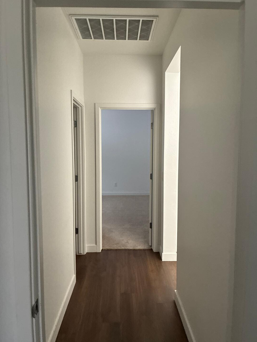 5630 South Daisy Patch Place Phoenix, AZ 85040 - Photo 5 of 14 an empty room with wooden floor and windows