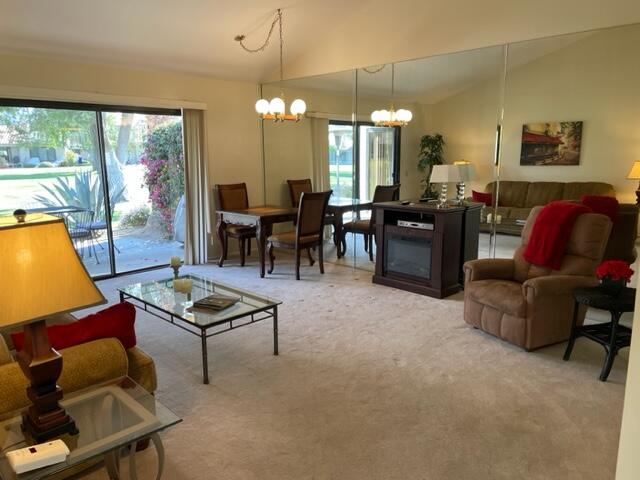 a living room with furniture a floor to ceiling window and a flat screen tv