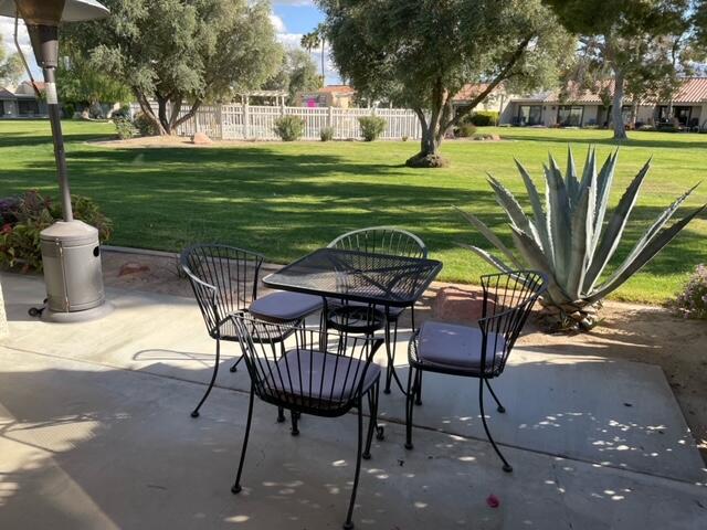 77413 Sawgrass Circle Palm Desert, CA 92211 - Photo 4 of 12 a view of a chairs and table in backyard