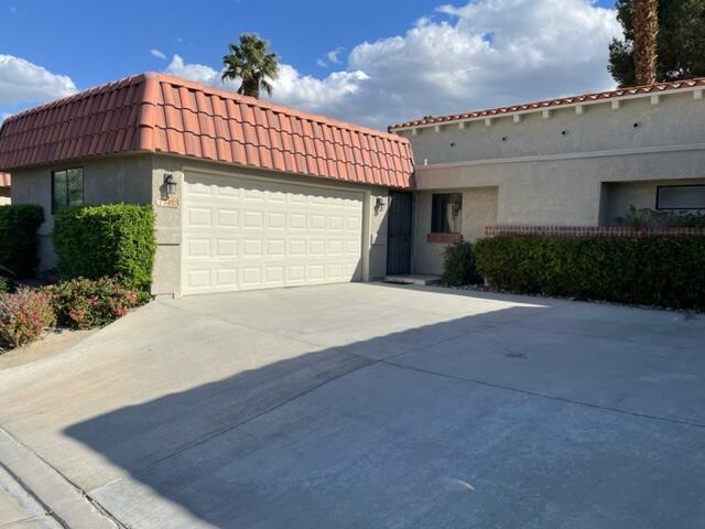 77413 Sawgrass Circle Palm Desert, CA 92211 - Photo 5 of 12 a view of a house with a garage