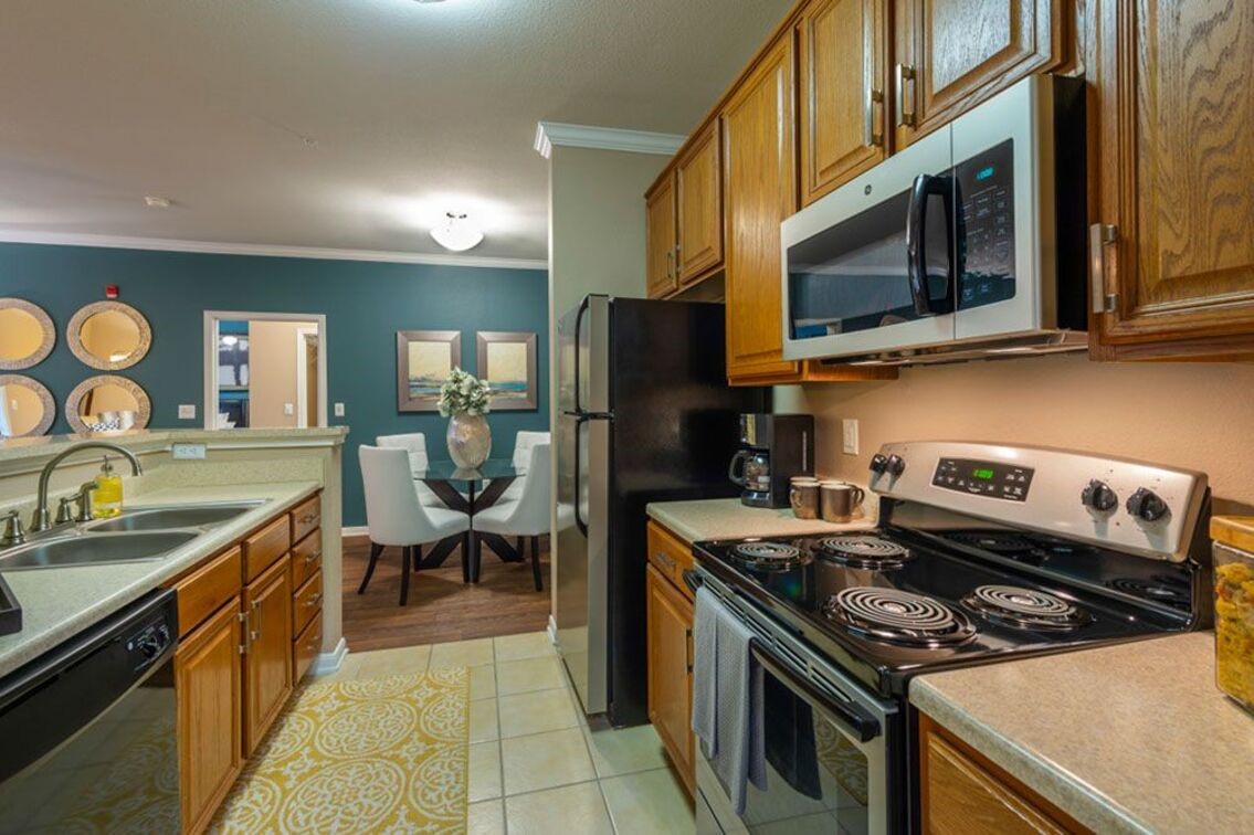 2840 Shadowbriar Drive, Unit B3 Houston, TX 77077 - Photo 11 of 22 a kitchen with a stove and a microwave