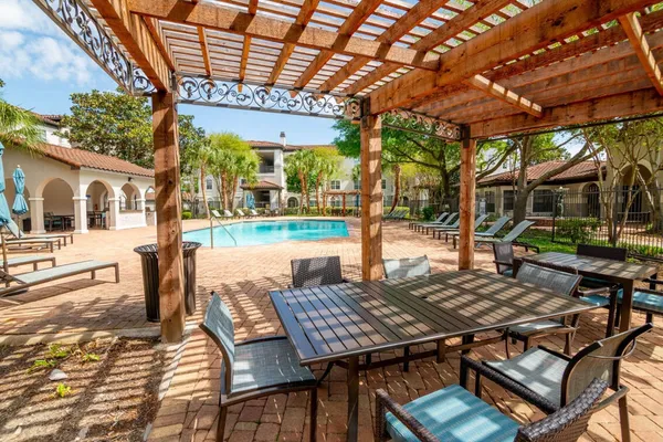 a view of a patio with table and chairs and potted plants