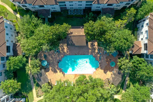 an aerial view of a house with a yard and garden