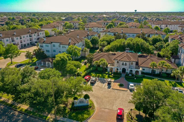 an aerial view of a houses with a yard