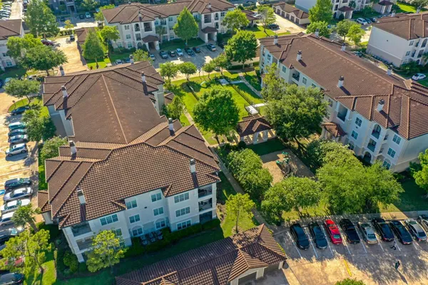 an aerial view of a house with yard