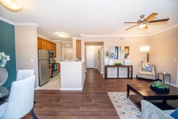 a living room with furniture and kitchen view