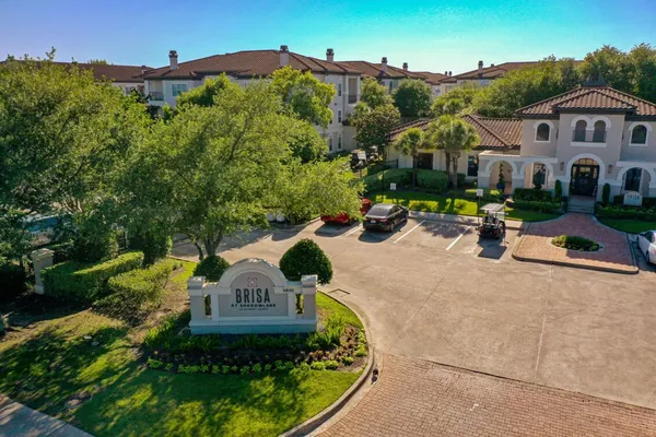 an aerial view of a house with garden space and street view