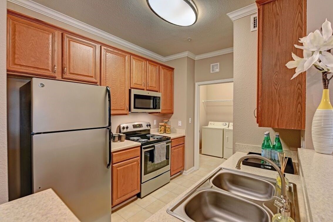 2840 Shadowbriar Drive, Unit B3 Houston, TX 77077 - Photo 7 of 22 a kitchen with a sink a refrigerator and cabinets