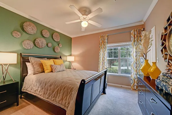 a bedroom with a bed and a window