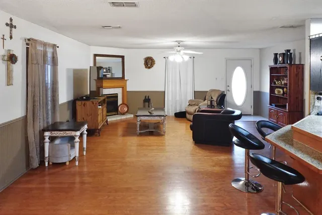 a living room with furniture gym equipment and a window