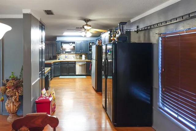 a kitchen with stainless steel appliances granite countertop a refrigerator and a sink