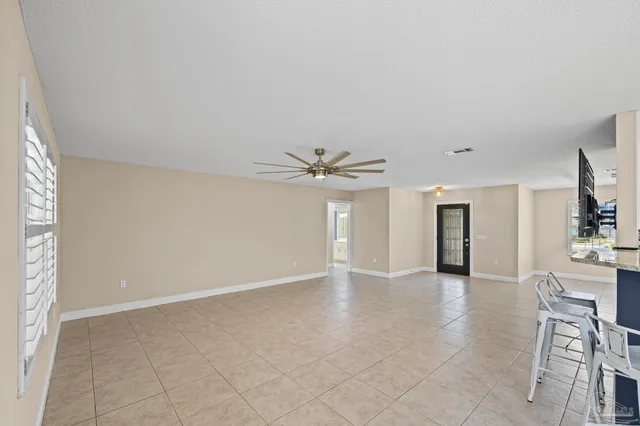 a large kitchen with granite countertop a stove a sink and a refrigerator