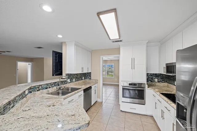 a bathroom with a sink and a white cabinets
