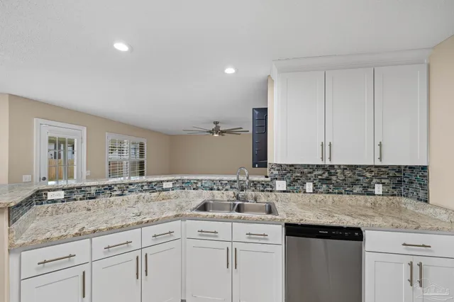 a bathroom with a granite countertop sink a mirror and a shower