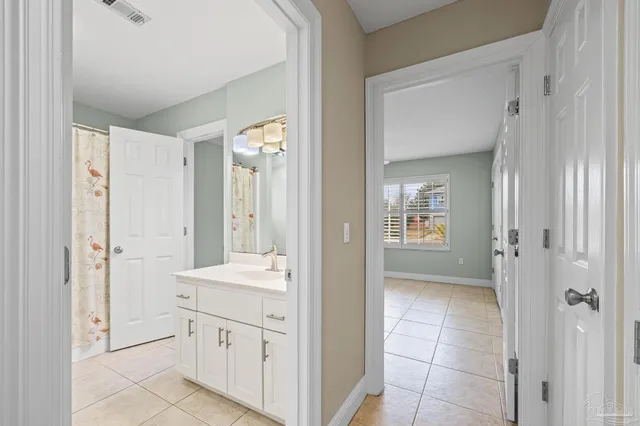 a view of an empty room with a ceiling fan