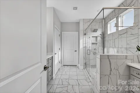 a bathroom with a shower and a glass door