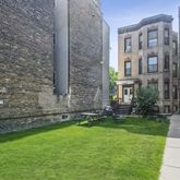a view of a brick building next to a yard