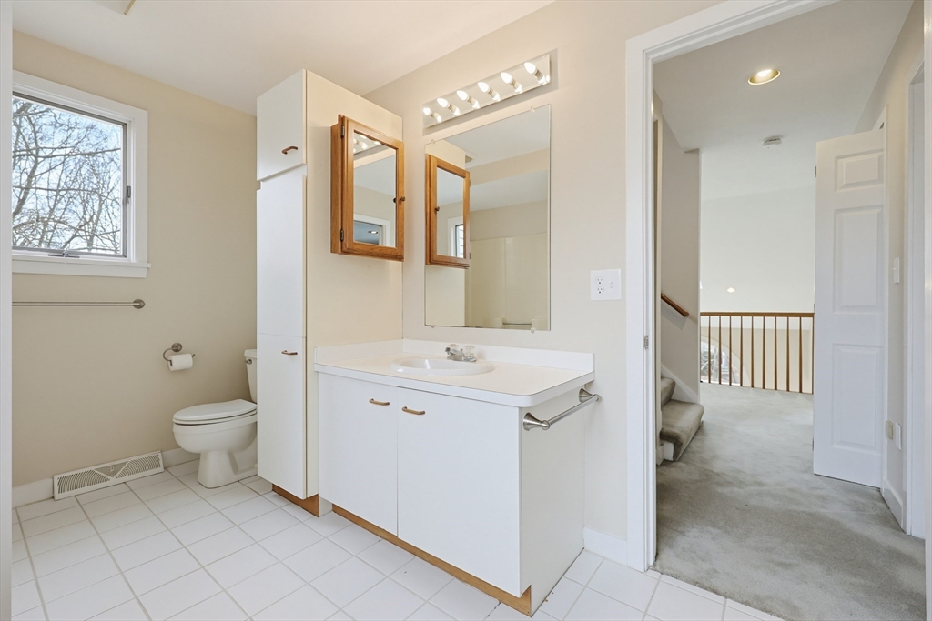 38 Poppasquash Road, Unit 38 North Attleboro, MA 02760 - Photo 17 of 36 a spacious bathroom with a granite countertop toilet sink and mirror