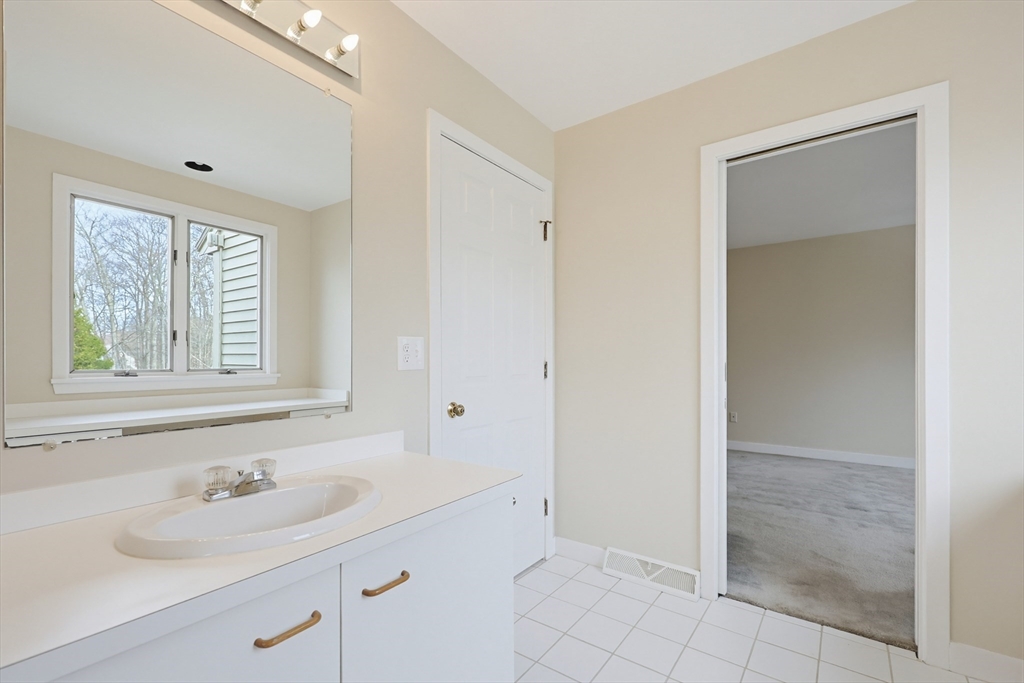 38 Poppasquash Road, Unit 38 North Attleboro, MA 02760 - Photo 18 of 36 a bathroom with a sink and a mirror