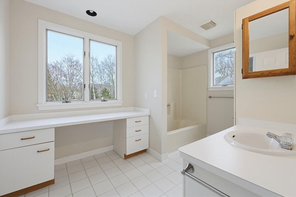 38 Poppasquash Road, Unit 38 North Attleboro, MA 02760 - Photo 19 of 36 a bathroom with a sink vanity and mirror