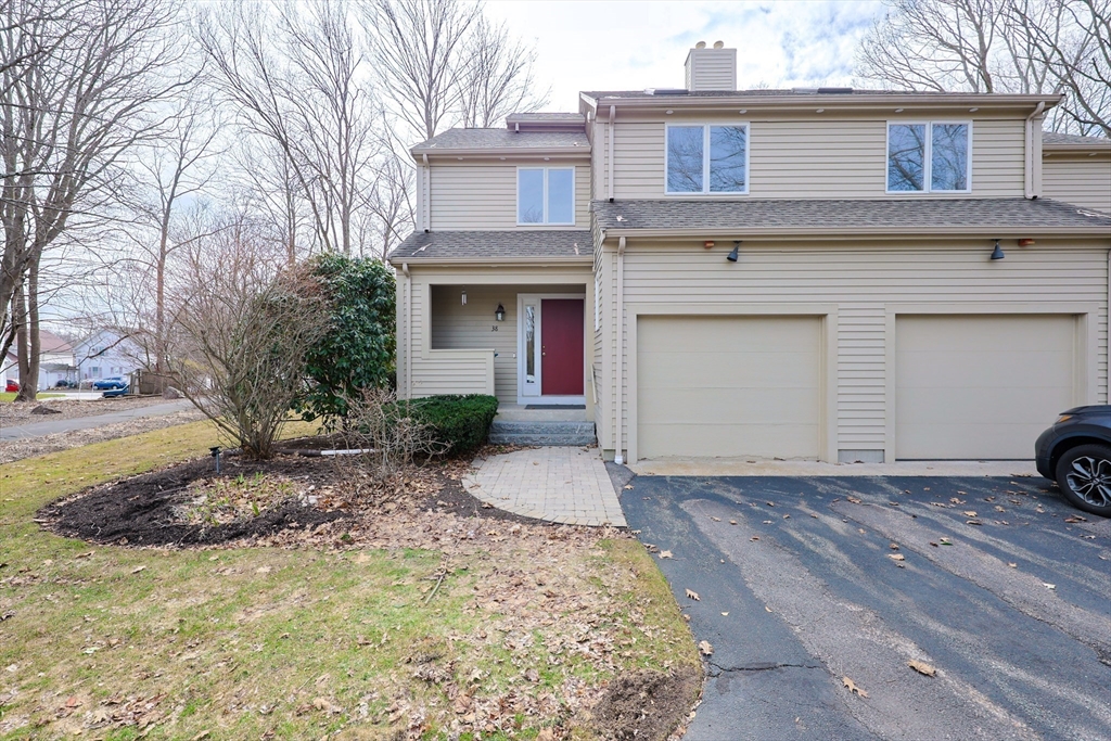 38 Poppasquash Road, Unit 38 North Attleboro, MA 02760 - Photo 2 of 36 a front view of a house with a yard and garage
