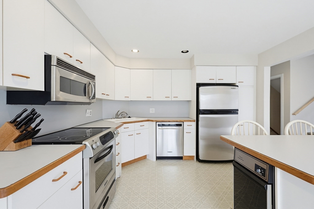 38 Poppasquash Road, Unit 38 North Attleboro, MA 02760 - Photo 5 of 36 a kitchen with stainless steel appliances granite countertop a stove a sink and a refrigerator