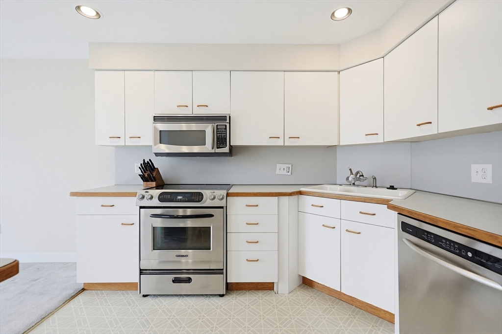 38 Poppasquash Road, Unit 38 North Attleboro, MA 02760 - Photo 6 of 36 a kitchen with cabinets stainless steel appliances and a sink