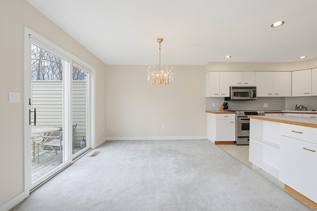 38 Poppasquash Road, Unit 38 North Attleboro, MA 02760 - Photo 9 of 36 a kitchen with granite countertop a stove a sink and a refrigerator