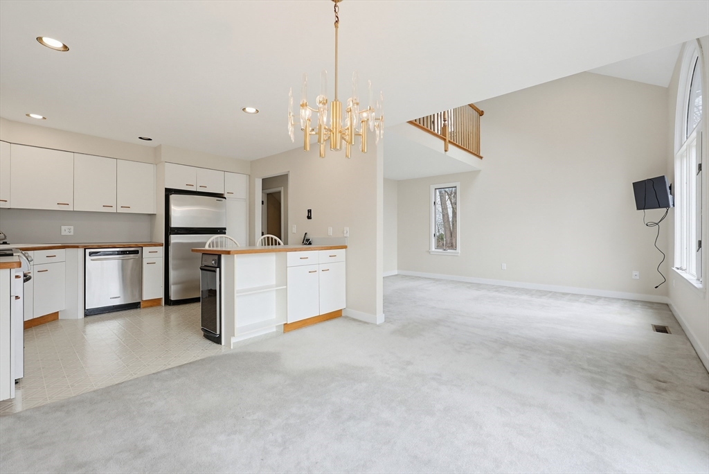 38 Poppasquash Road, Unit 38 North Attleboro, MA 02760 - Photo 10 of 36 a view of a kitchen with a sink and dishwasher a refrigerator with wooden floor