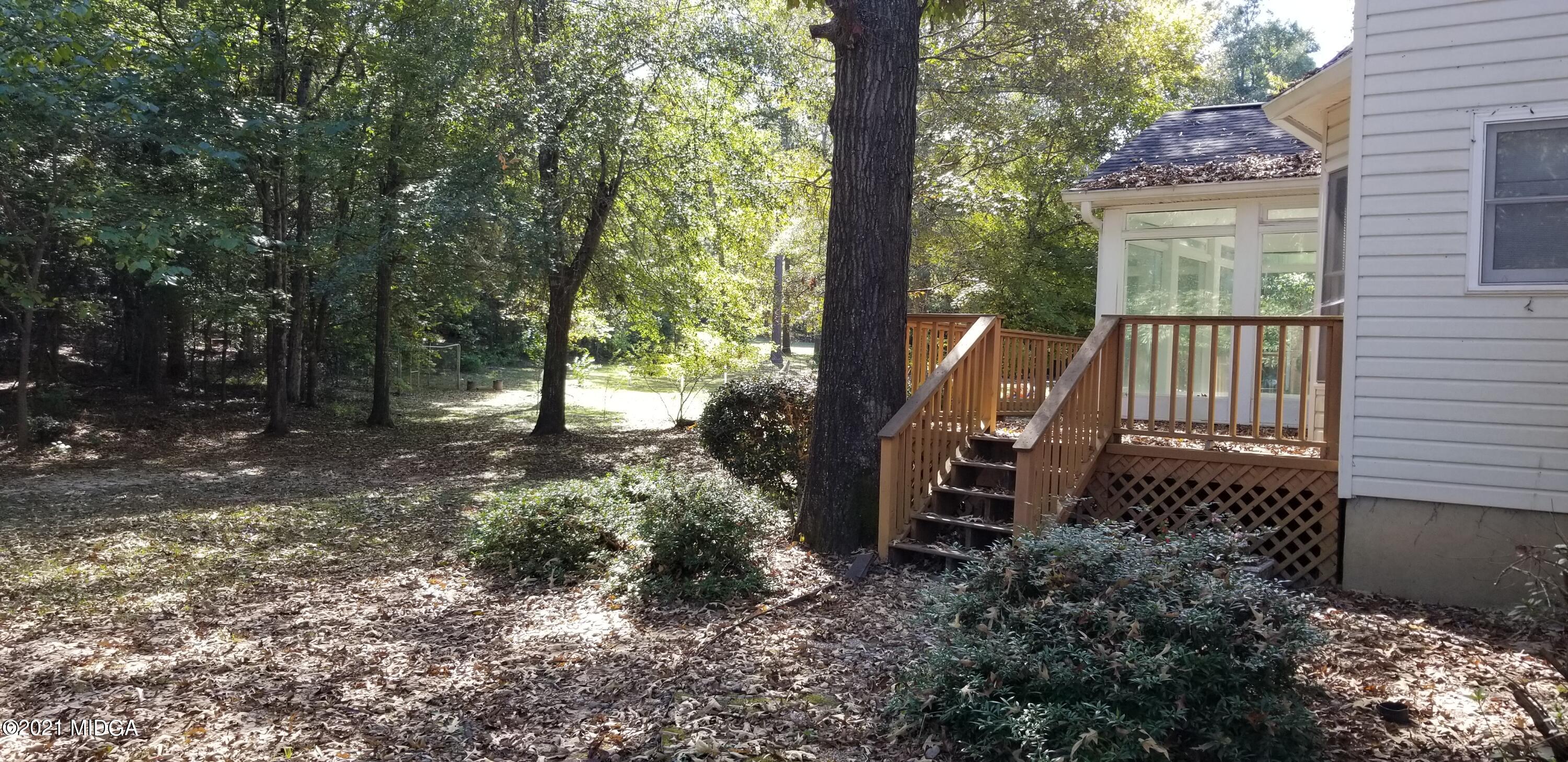 208 Gates Road Lizella, GA 31052 - Photo 47 of 55 a view of a wooden bench sitting in backyard
