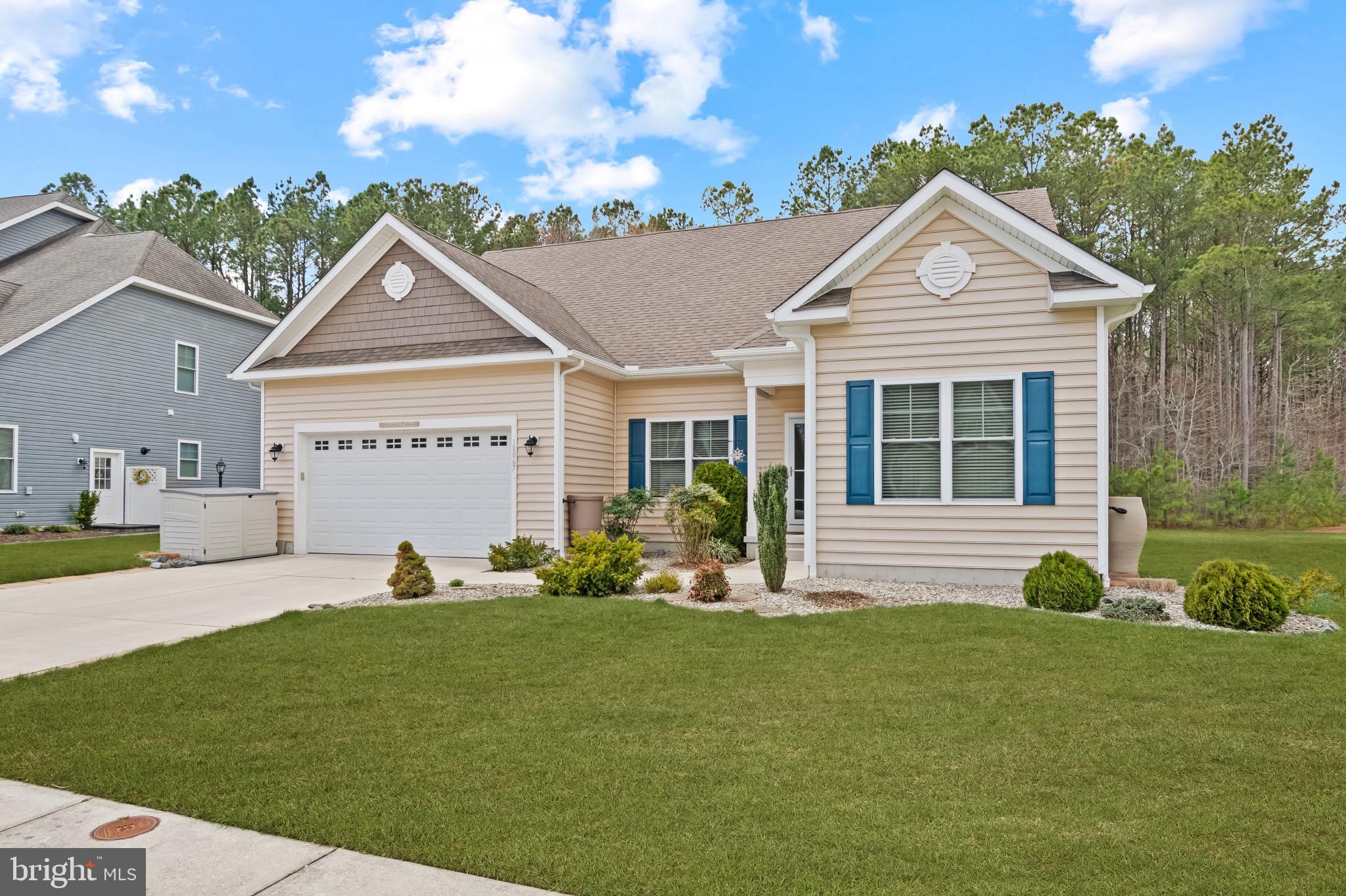 18067 Emerson Way Georgetown, DE 19947 - Photo 1 of 37 a front view of a house with garden