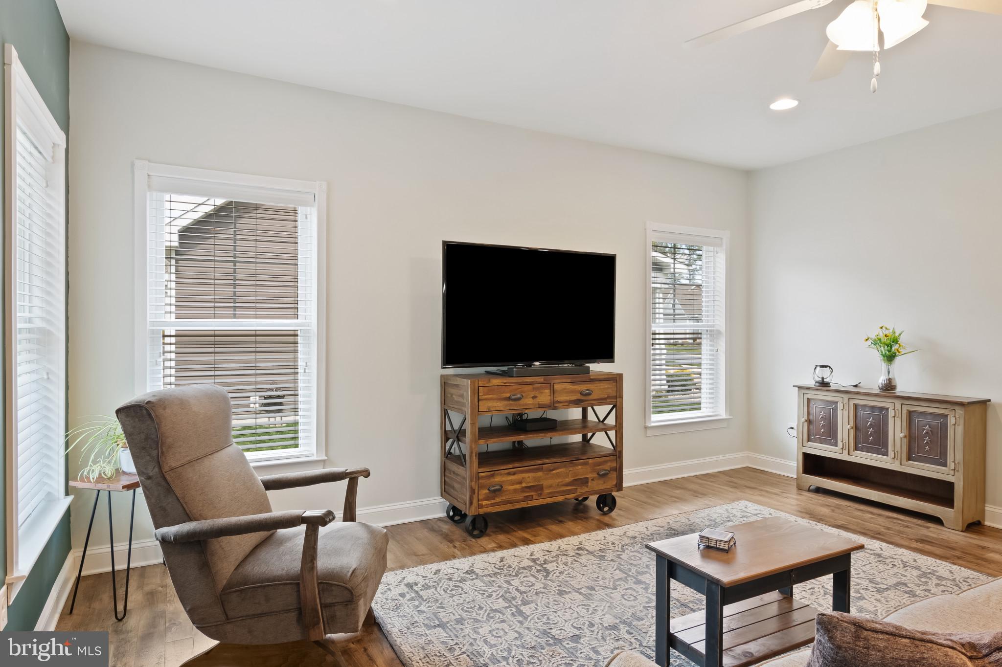 18067 Emerson Way Georgetown, DE 19947 - Photo 11 of 37 a living room with furniture and a flat screen tv