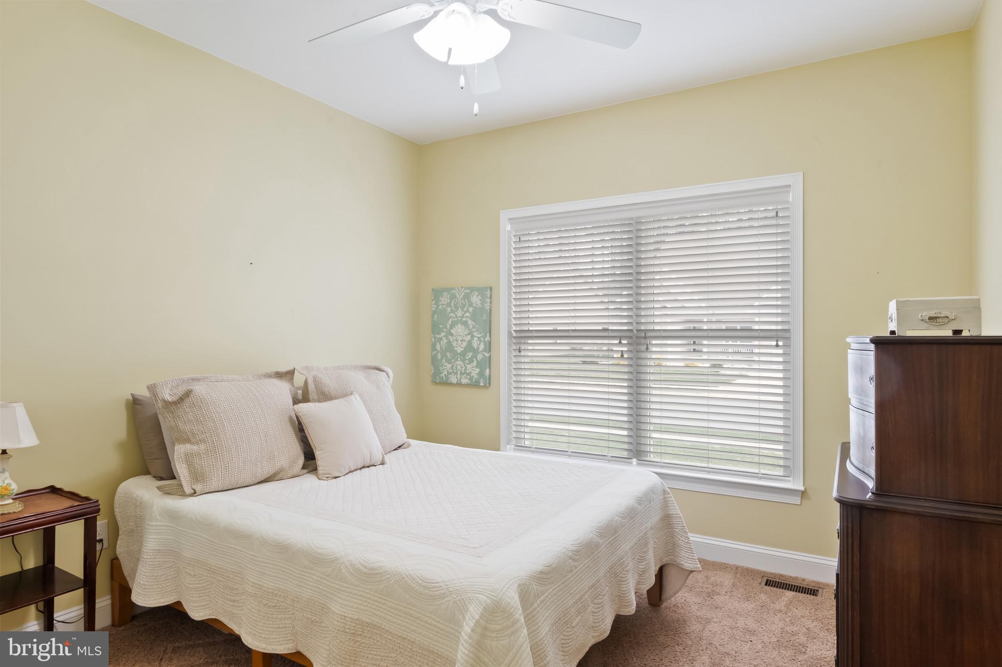 18067 Emerson Way Georgetown, DE 19947 - Photo 13 of 37 a bedroom with a bed and a window