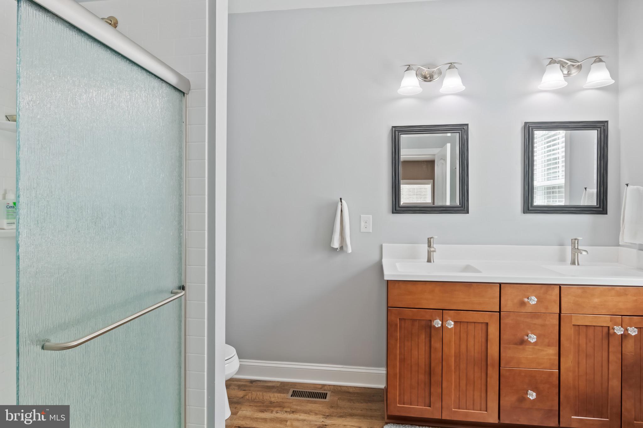 18067 Emerson Way Georgetown, DE 19947 - Photo 14 of 37 a bathroom with a granite countertop sink and a mirror