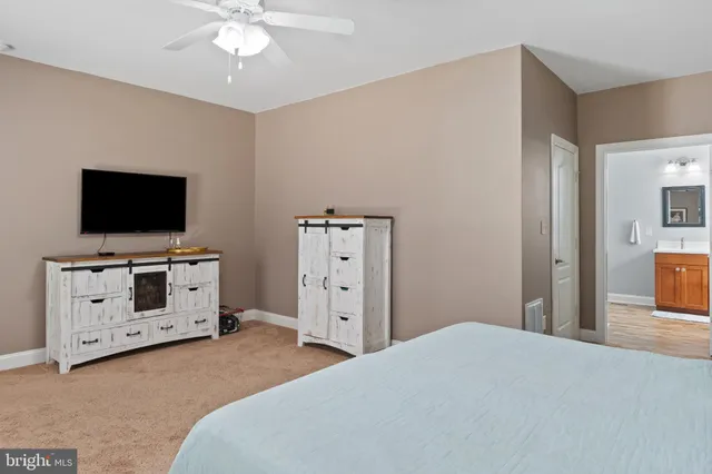 a view of a bedroom with wooden floor and cabinet