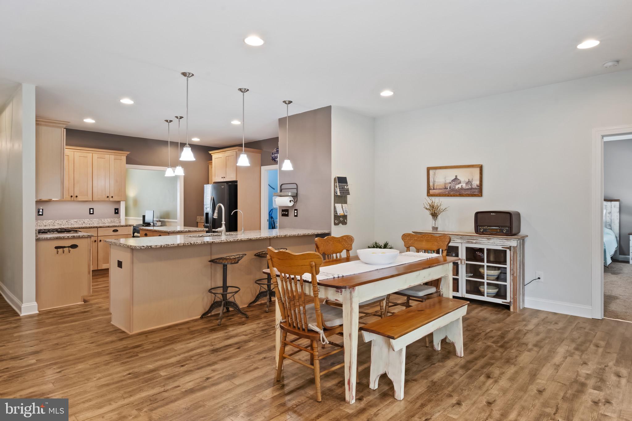 18067 Emerson Way Georgetown, DE 19947 - Photo 22 of 37 a large kitchen with a table and chairs in it