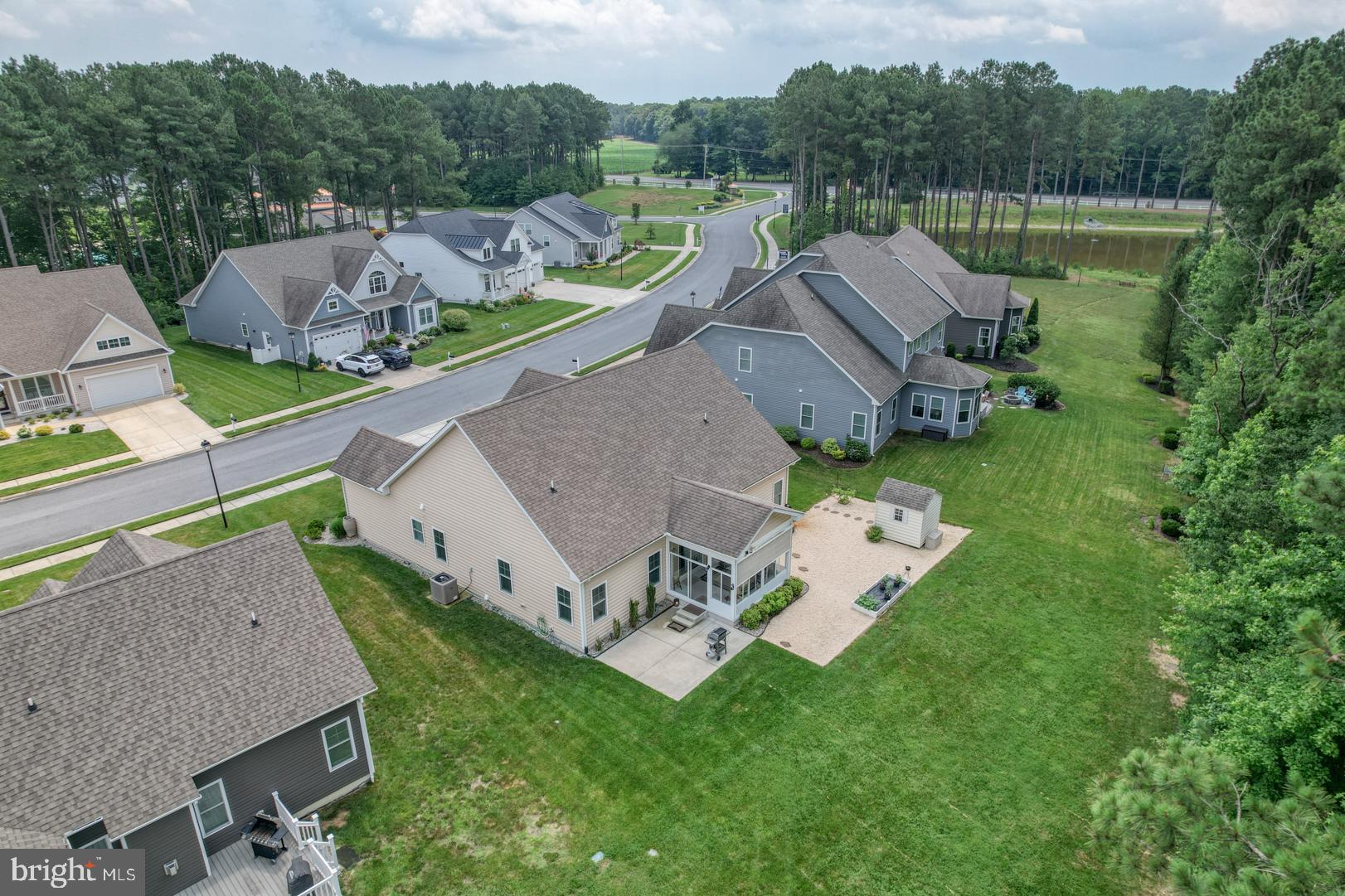 18067 Emerson Way Georgetown, DE 19947 - Photo 27 of 37 an aerial view of a house with a garden and lake view