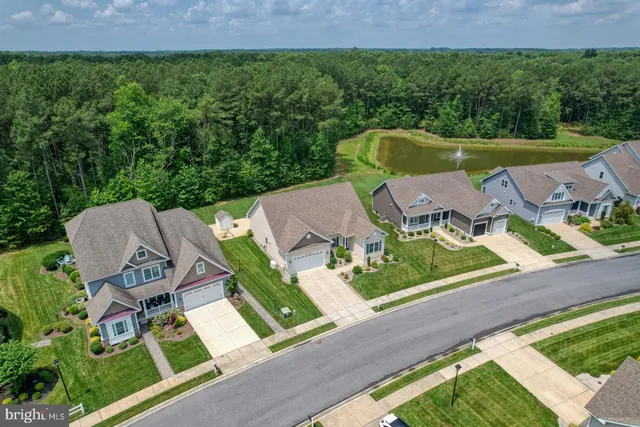 an aerial view of a house with a garden and a yard