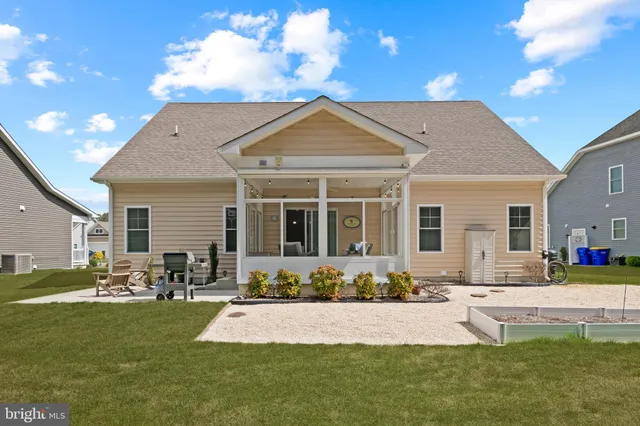 a backyard of a house with table and chairs