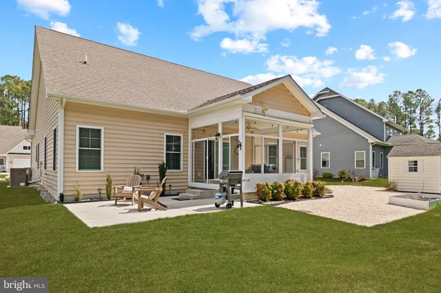 a front view of a house with a yard and outdoor seating
