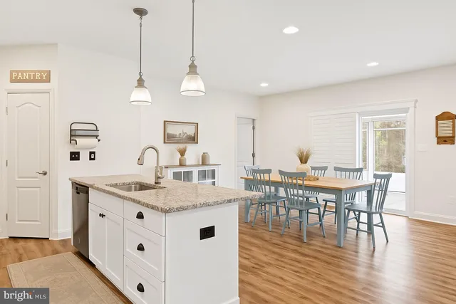 a view of kitchen with cabinets table and chairs