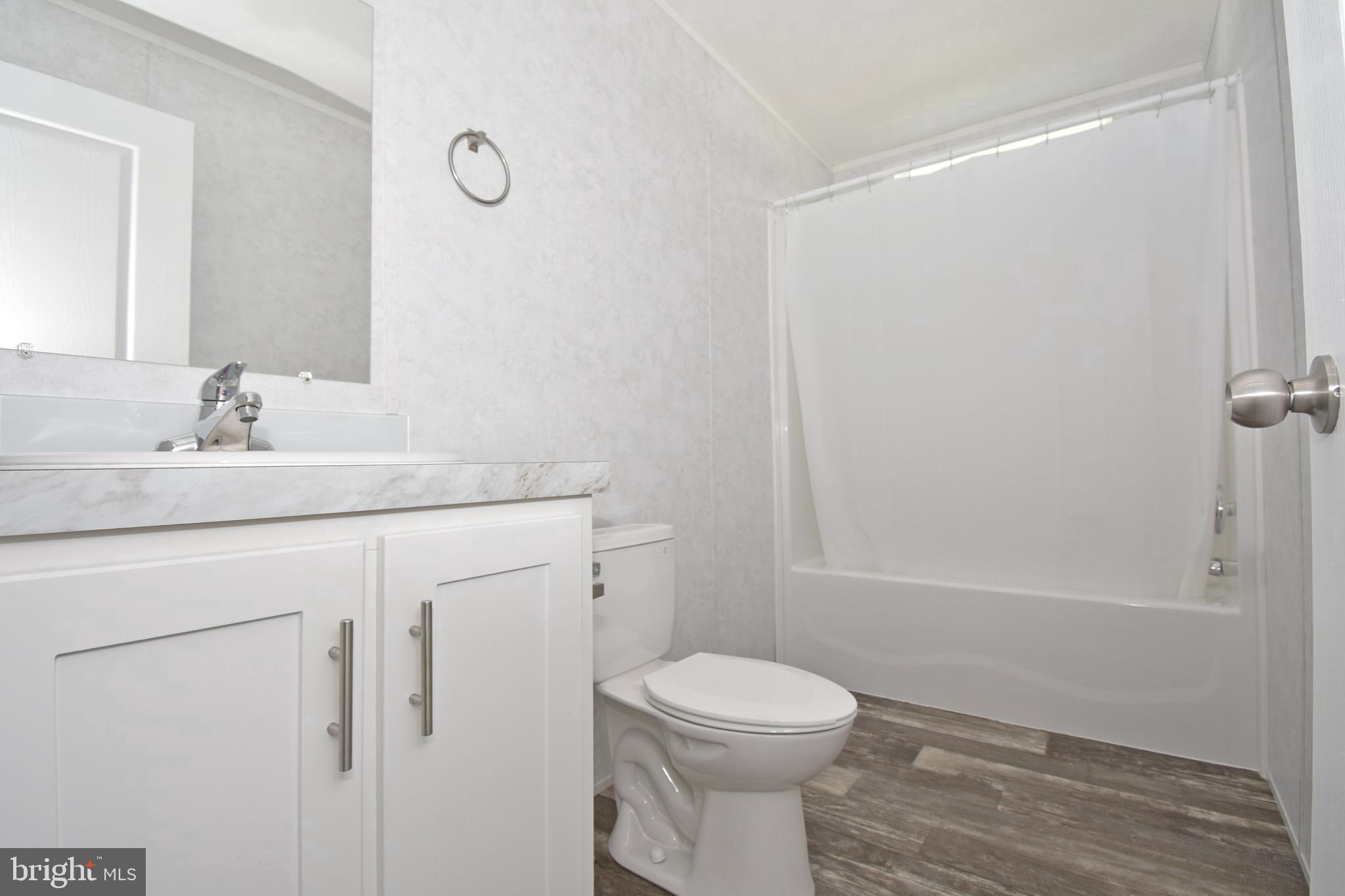 5814 Homestead Street Salisbury, MD 21801 - Photo 9 of 12 a bathroom with a sink a toilet and shower