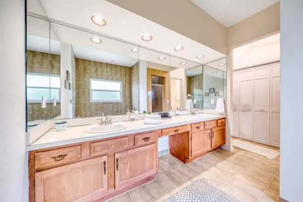 a large white kitchen with a sink and cabinets