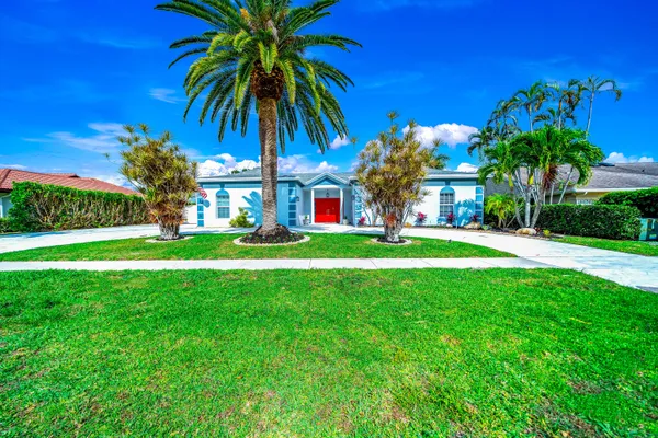 a front view of house with yard and green space