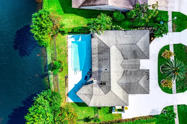 an aerial view of a house with a yard and garden