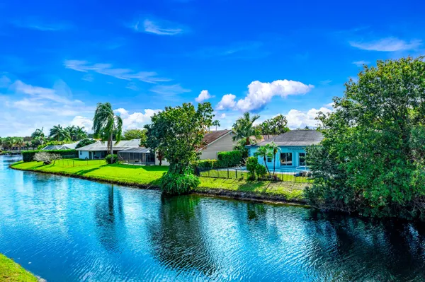 a view of a lake with a house swimming pool and outdoor space