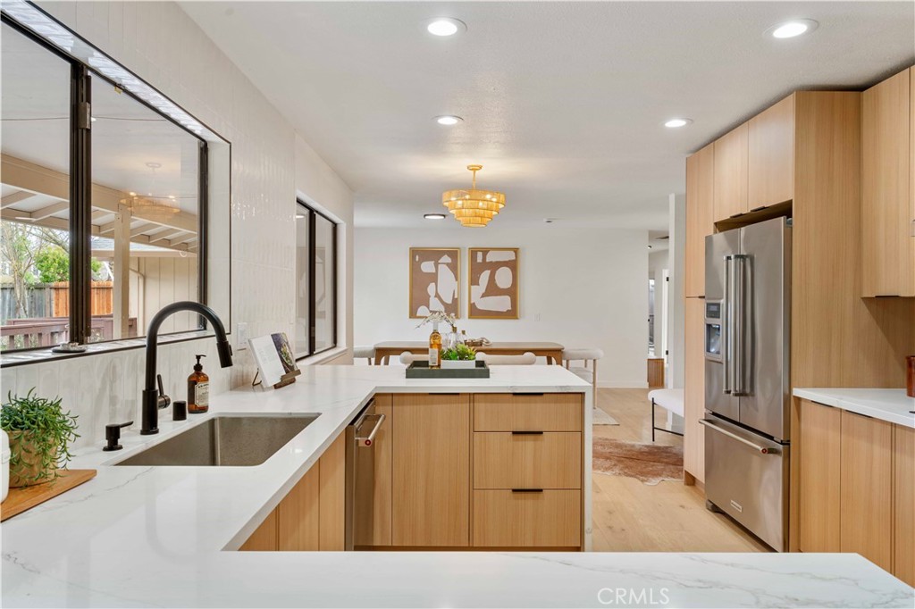 931 Camino Ramon Danville, CA 94526 - Photo 30 of 67 a kitchen with stainless steel appliances kitchen island granite countertop a sink refrigerator and cabinets