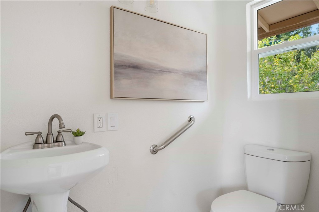 931 Camino Ramon Danville, CA 94526 - Photo 42 of 67 a bathroom with a toilet sink and mirror